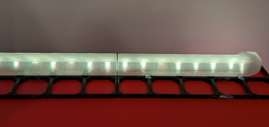 LED diffuser over a aRGB LED strip.  Bright spots of individual LEDs can be seen through the diffuser. Although they are more blended than without a diffuser.